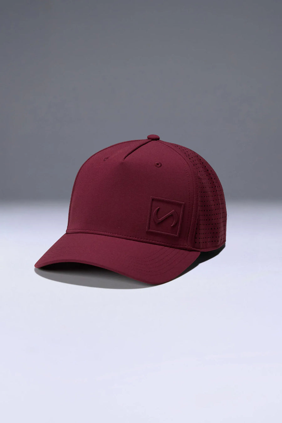 Wine Aero Core Performance Gym Hat with laser ventilation, water-repellent fabric and structured snapback fit by TLF Apparel – side view 