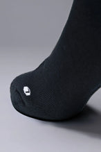 Detail Toe View of Black the TLF Evolve Half Crew Socks featuring an extended cuff height, ribbed cuff, cushioned footbed and seamless toe