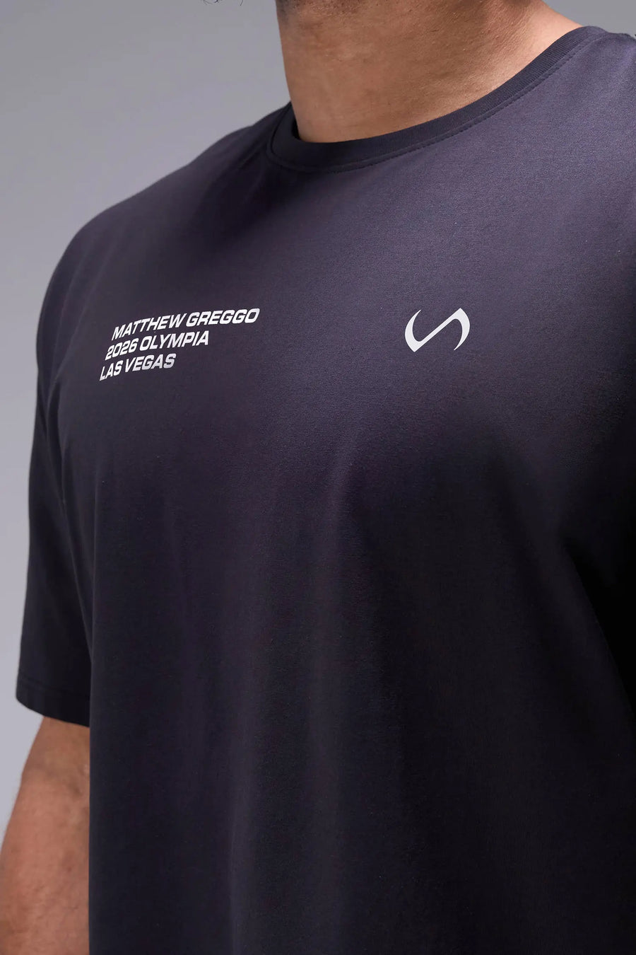 Black TLF x Matt Greggo Cotton Luxe Oversized Tee showing side split hem, woven hem clip label, and Cotton Luxe DNA fabric by TLF Apparel – detail view