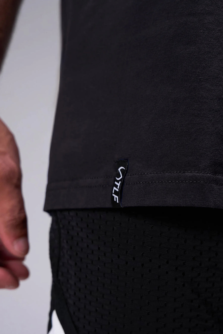 Black Ronnie Coleman “Light weight baby” Tee showing premium Cotton Luxe DNA™ fabric texture and Ronnie Coleman x TLF graphic detail by TLF Apparel – detail 