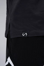 Black Sinister Cotton Luxe Oversized Tee showing side split hem, woven hem clip label, and Cotton Luxe DNA fabric by TLF Apparel – detail view
