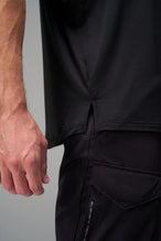 Black Further Air-Flex Drop Arm Tank showing ultra-soft performance fabric and Take Life Further® chest logo detail by TLF Apparel – detail view