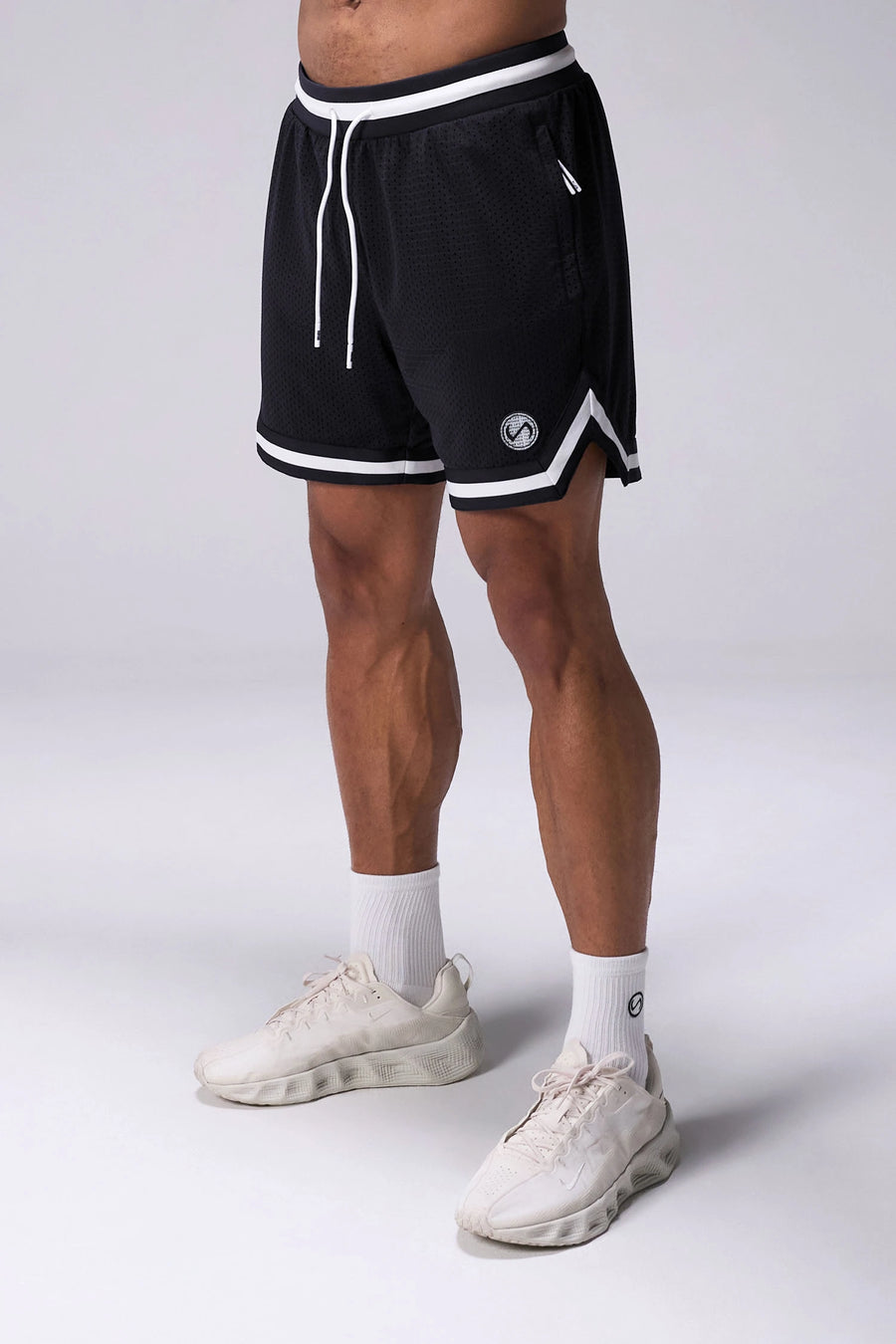 Black TLF Evolve Mesh 6 Inch Shorts with lightweight breathable mesh fabric, zip pockets, and 4-way stretch performance for gym training and workouts by TLF Apparel – front view