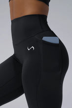 Black Tempo Leggings With Pockets showing Luxe DNA™ fabric texture and Hi-Tech Gel TLF logo by TLF Apparel – detail view