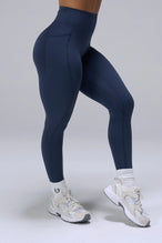 Navy Tempo Leggings With Pockets showing sculpted thigh and full-length leg silhouette by TLF Apparel – side view