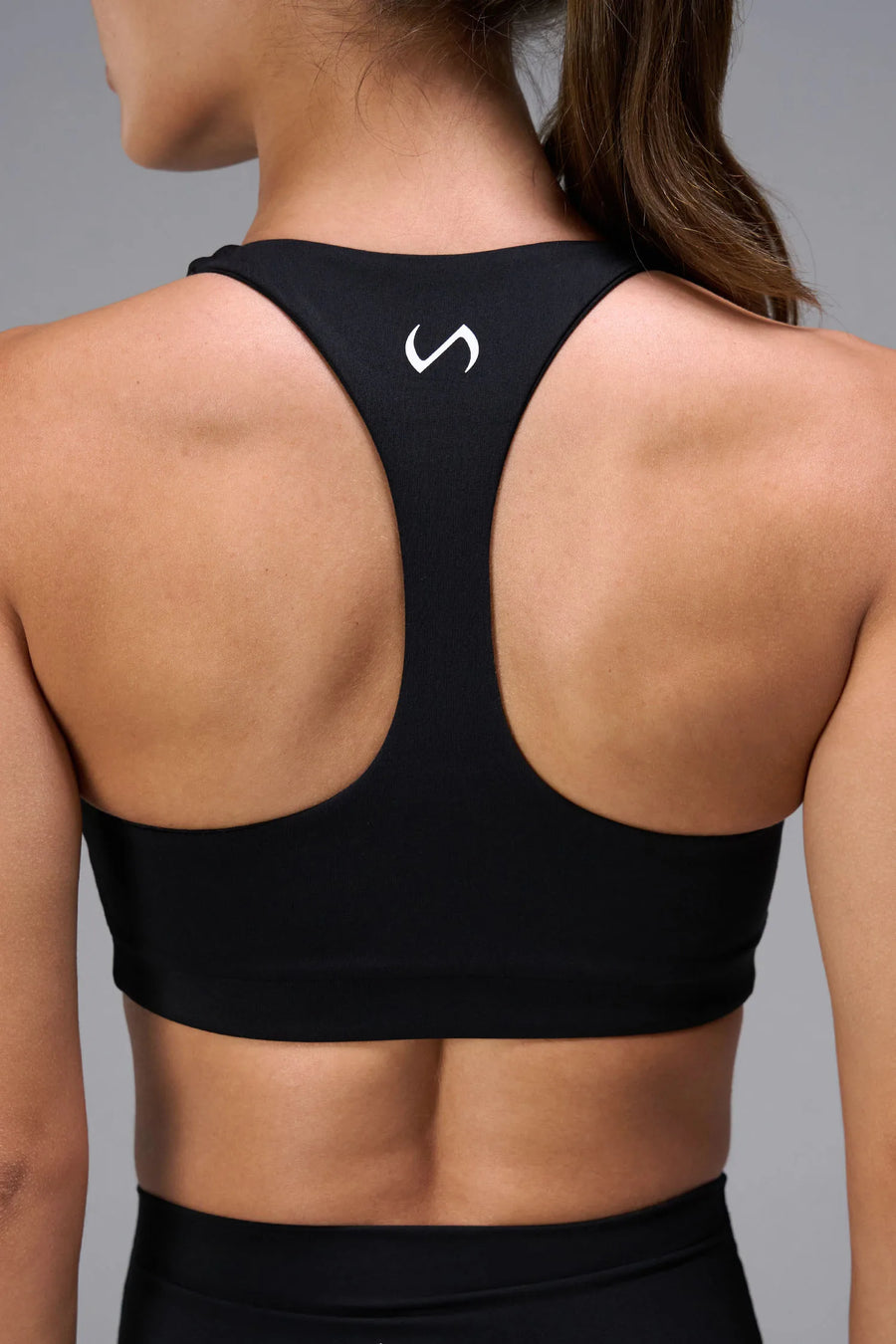 Black Tempo Racerback Sports Bra showing racerback design for full range of motion by TLF Apparel – back view