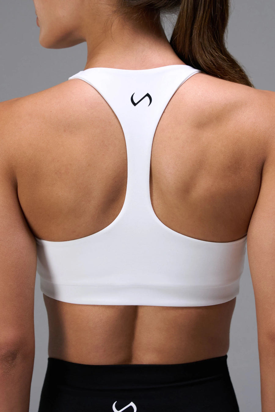 White Tempo Racerback Sports Bra showing racerback design for full range of motion by TLF Apparel – back view