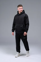 Side View of Black TLF Scuba Tech Contrast Stitch Joggers, featuring side zipper pockets and contrast stitching for streetwear aesthetic