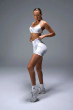 Side View of White TLF Cosmic Seamless Scrunch Butt Shorts, featuring a scrunch butt to shape and contour your glutes 