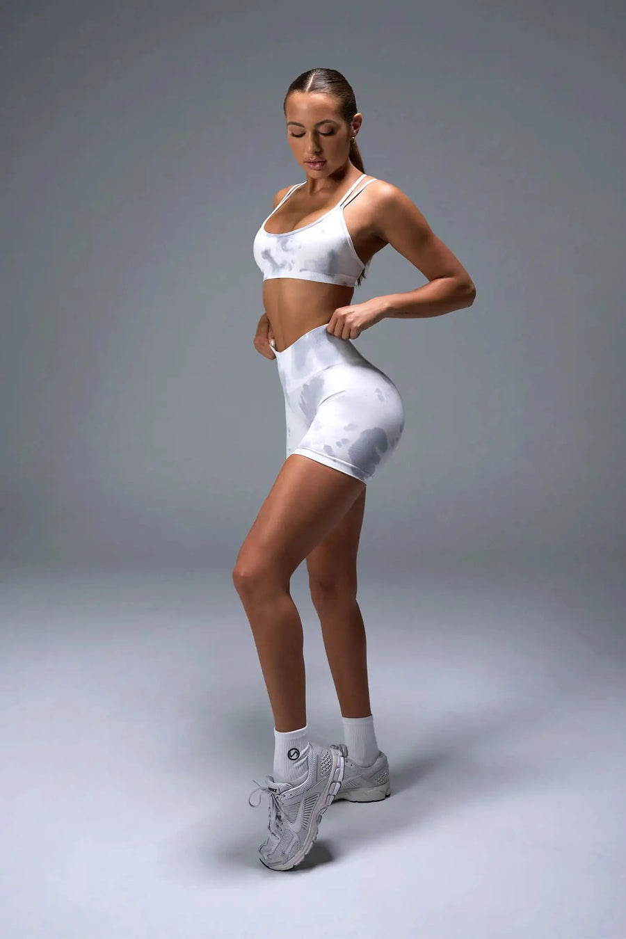 Side View of White TLF Cosmic Seamless Scrunch Butt Shorts, featuring a scrunch butt to shape and contour your glutes 