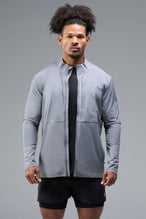 Front View of Gray TLF Element Athletic Jacket, featuring multiple zipper pockets, and ripstop panels for breathability and stretch 