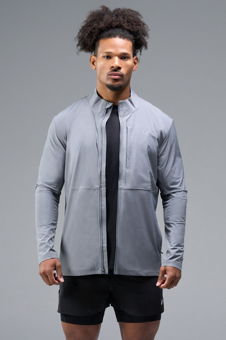 Front View of Gray TLF Element Athletic Jacket, featuring multiple zipper pockets, and ripstop panels for breathability and stretch 
