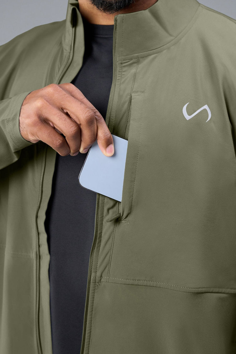 Detail Front View of Green TLF Element Athletic Jacket, featuring multiple zipper pockets, and ripstop panels for breathability and stretch 