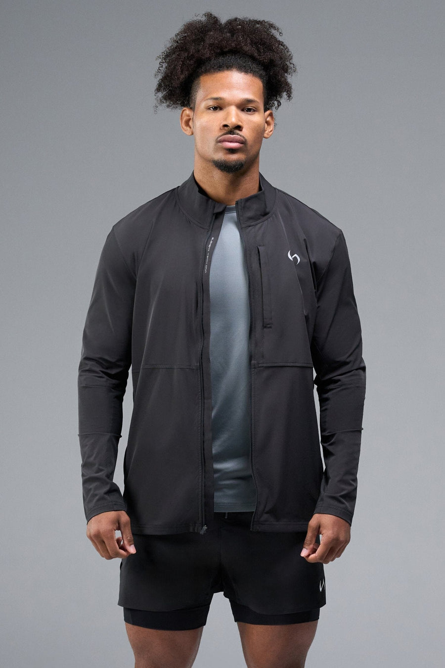 Front View of Black TLF Element Athletic Jacket, featuring multiple zipper pockets, and ripstop panels for breathability and stretch 