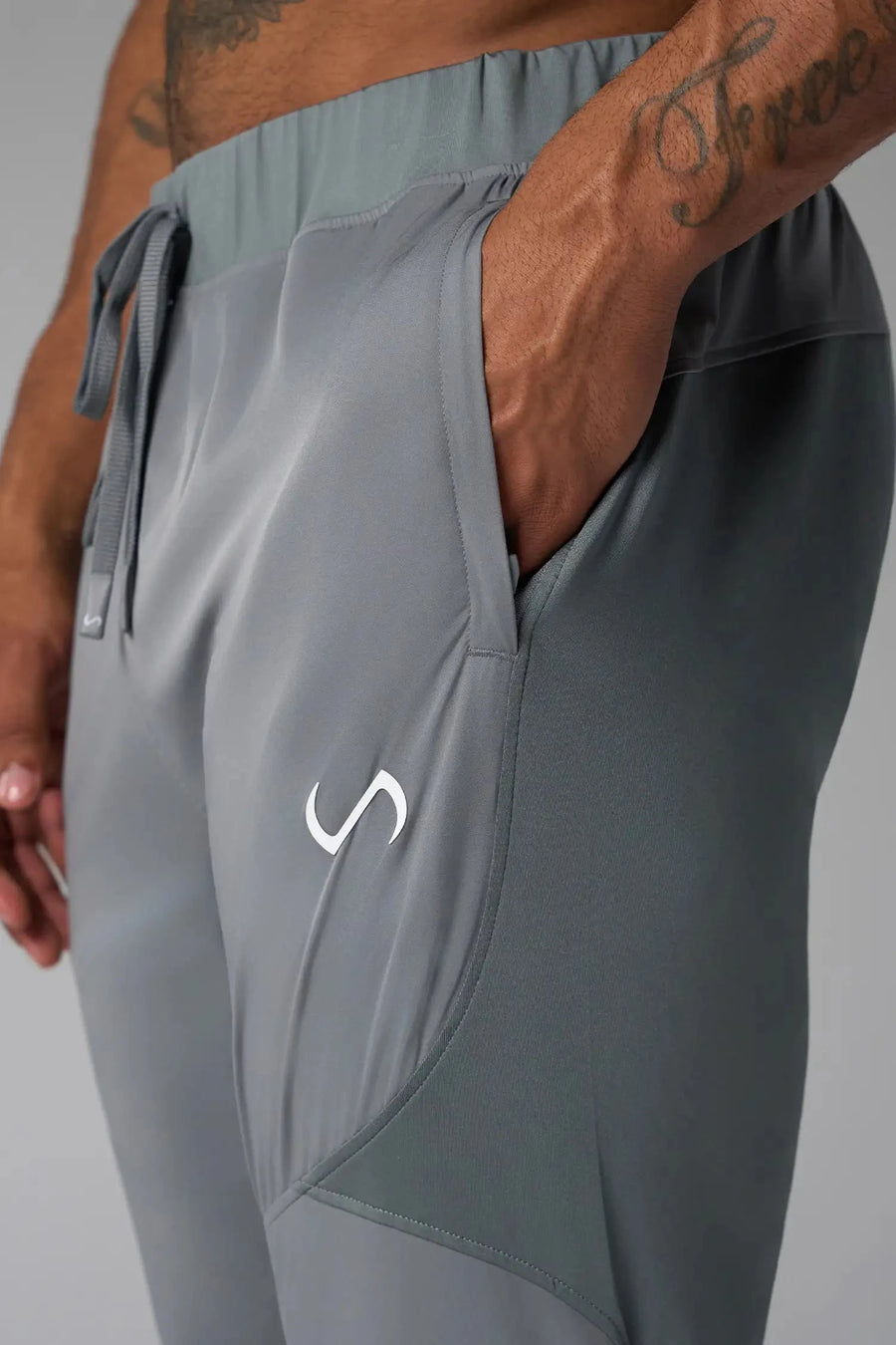 Side View of Gray the TLF Element Infi-Dry Hybrid Joggers featuring side zipper pockets, zippered ankles and drawcord waistband for a custom fit. 