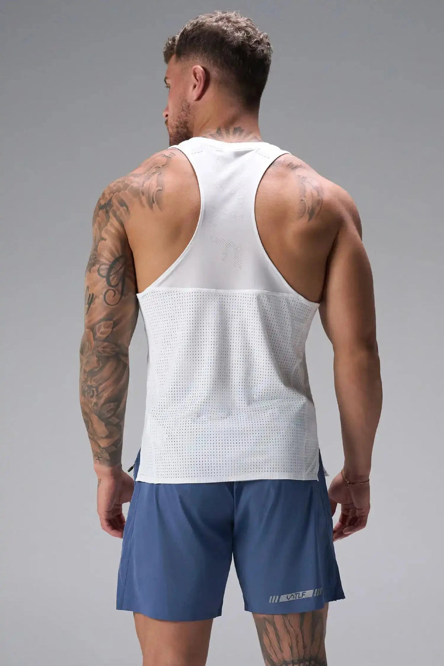 Back View of the Blue TLF Element Light 7 Inch Shorts featuring side zipper pockets, side split hems and reflective details for nighttime visibility