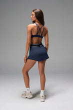 Back View of Blue TLF Element workout skirt featuring built in 2.5-inch inseam shorts and side pockets
