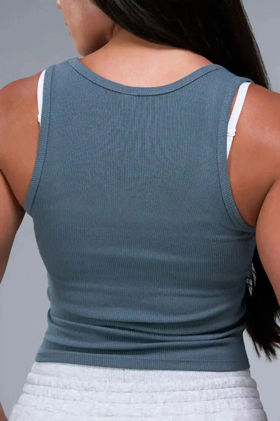 Back View of Blue TLF Essential Ribbed Tank Top, featuring a scoop neckline in our ribbed tech fabric 