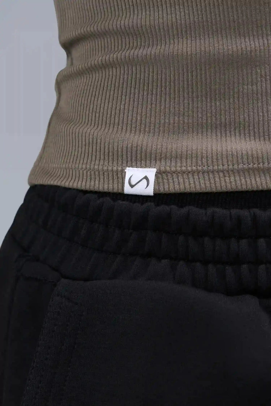 Detail Logo View of Brown TLF Essential Ribbed Tank Top, featuring a scoop neckline in our ribbed tech fabric