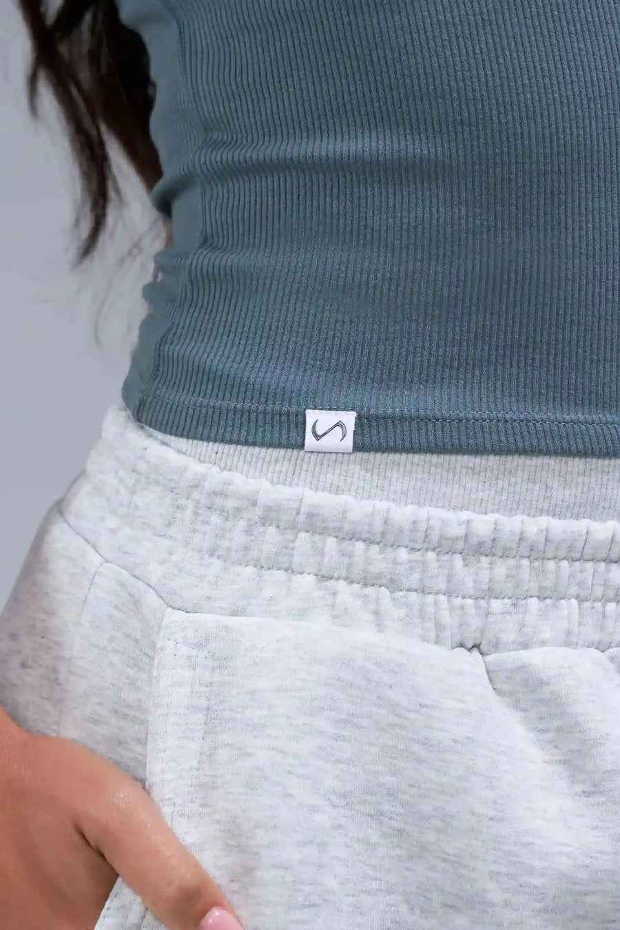 Detail Logo View of Blue TLF Essential Ribbed Tank Top, featuring a scoop neckline in our ribbed tech fabric 