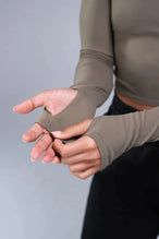 Detail Sleeves View of Brown TLF Essential Seamless off the shoulder top, featuring a cropped length and thumbholes 