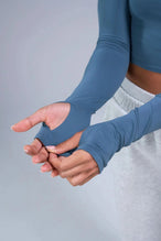 Detail Sleeves View of Blue TLF Essential Seamless off the shoulder top, featuring a cropped length and thumbholes 