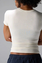 Back View of White the TLF Fitted Crew Neck T-Shirt featuring a long line silhouette and whip stitch detailing. 
