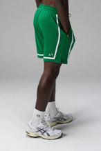Side View of Green GTS Athletic 8 Inch Shorts, featuring an 8-inch inseam and zipper pockets