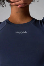 Back View of Blue the TLF GTS Cropped Baby Tee features sporty raglan sleeves, cropped length and premium whip stitch detailing. 