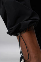 Detail View of Black the TLF GTS Element-Max Cargo Pants featuring front cargo pockets and an adjustable ankle drawcord ankle for custom fit