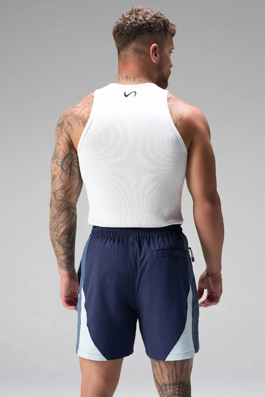 Back View of Blue the TLF GTS Element-Max Shorts featuring contrast color panels and sleek invisible side zipper pockets