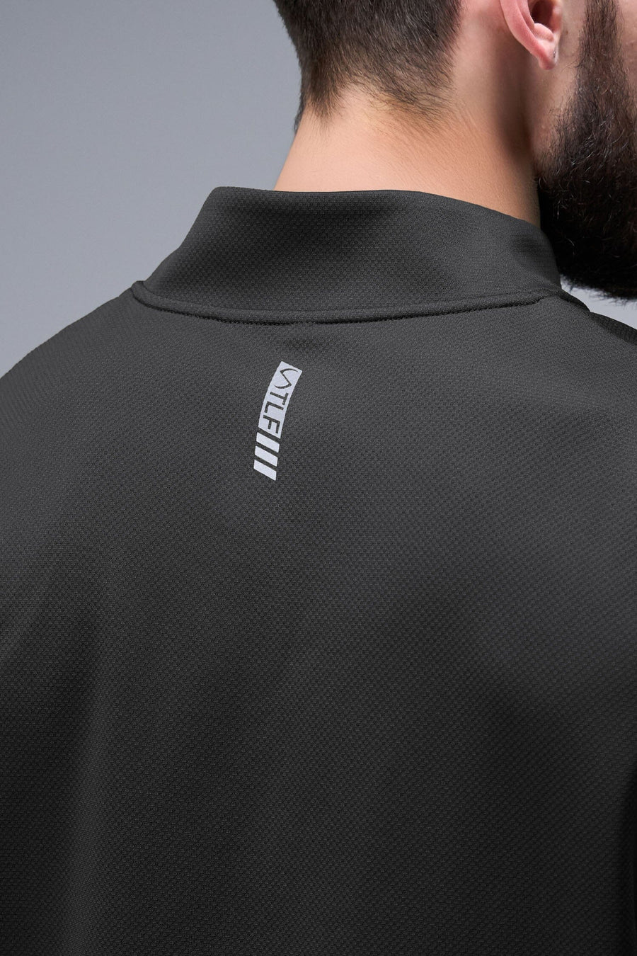 Detail Back View of Black TLF GTS Quad Tech Quarter-Zip Pullover redefining modern activewear, this men’s 1/4 zip pullover blends technology with sleek style 