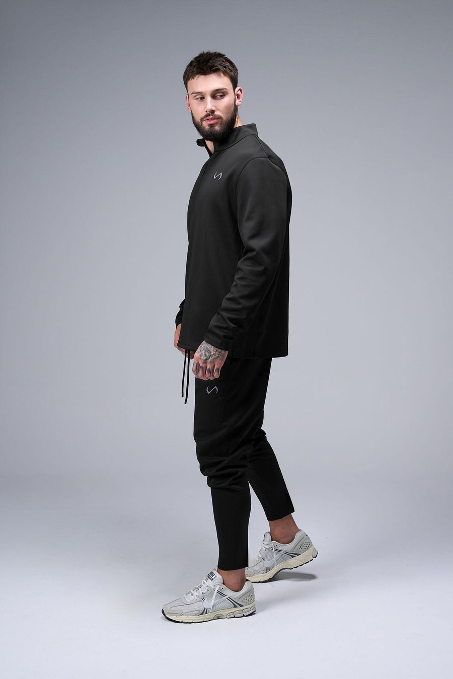 Left Side View of Black TLF GTS Quad Tech Quarter-Zip Pullover redefining modern activewear, this men’s 1/4 zip pullover blends technology with sleek style 