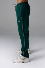 Side View of Green TLF GTS Twill Tech Joggers, featuring contrast stitching, zippered pockets, and next level style and function