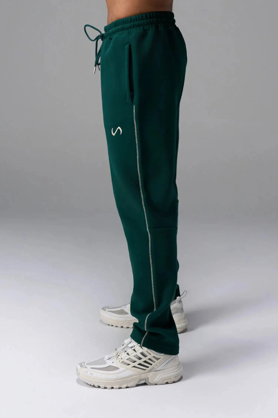 Side View of Green TLF GTS Twill Tech Joggers, featuring contrast stitching, zippered pockets, and next level style and function
