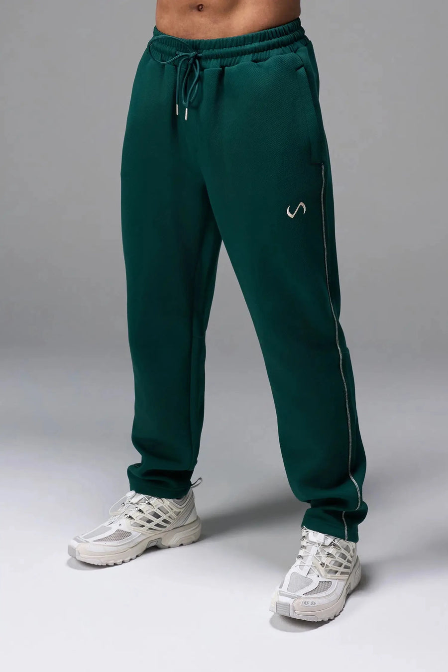 Front View of Green TLF GTS Twill Tech Joggers, featuring contrast stitching, zippered pockets, and next level style and function