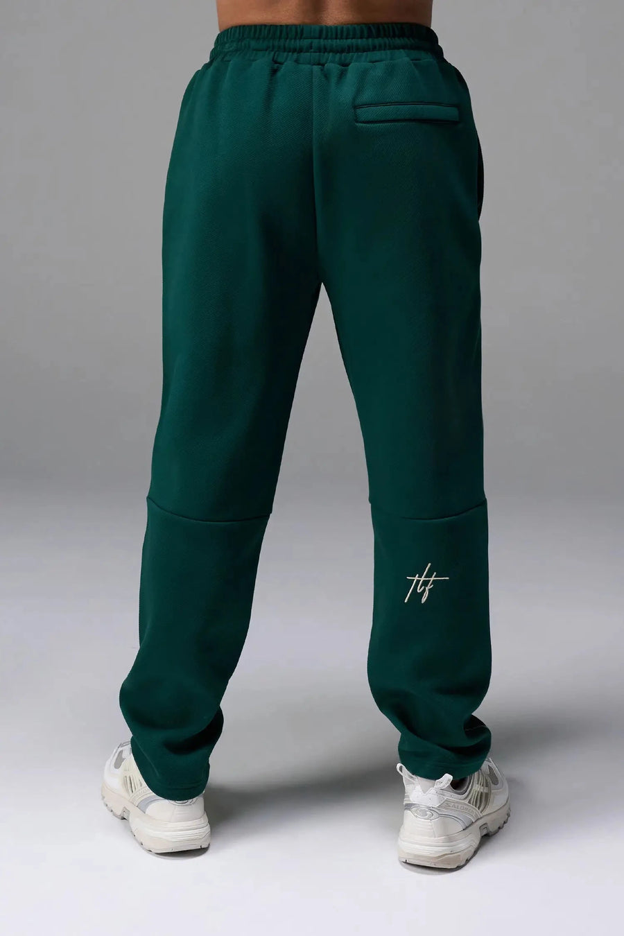 Back View of Green TLF GTS Twill Tech Joggers, featuring contrast stitching, zippered pockets, and next level style and function