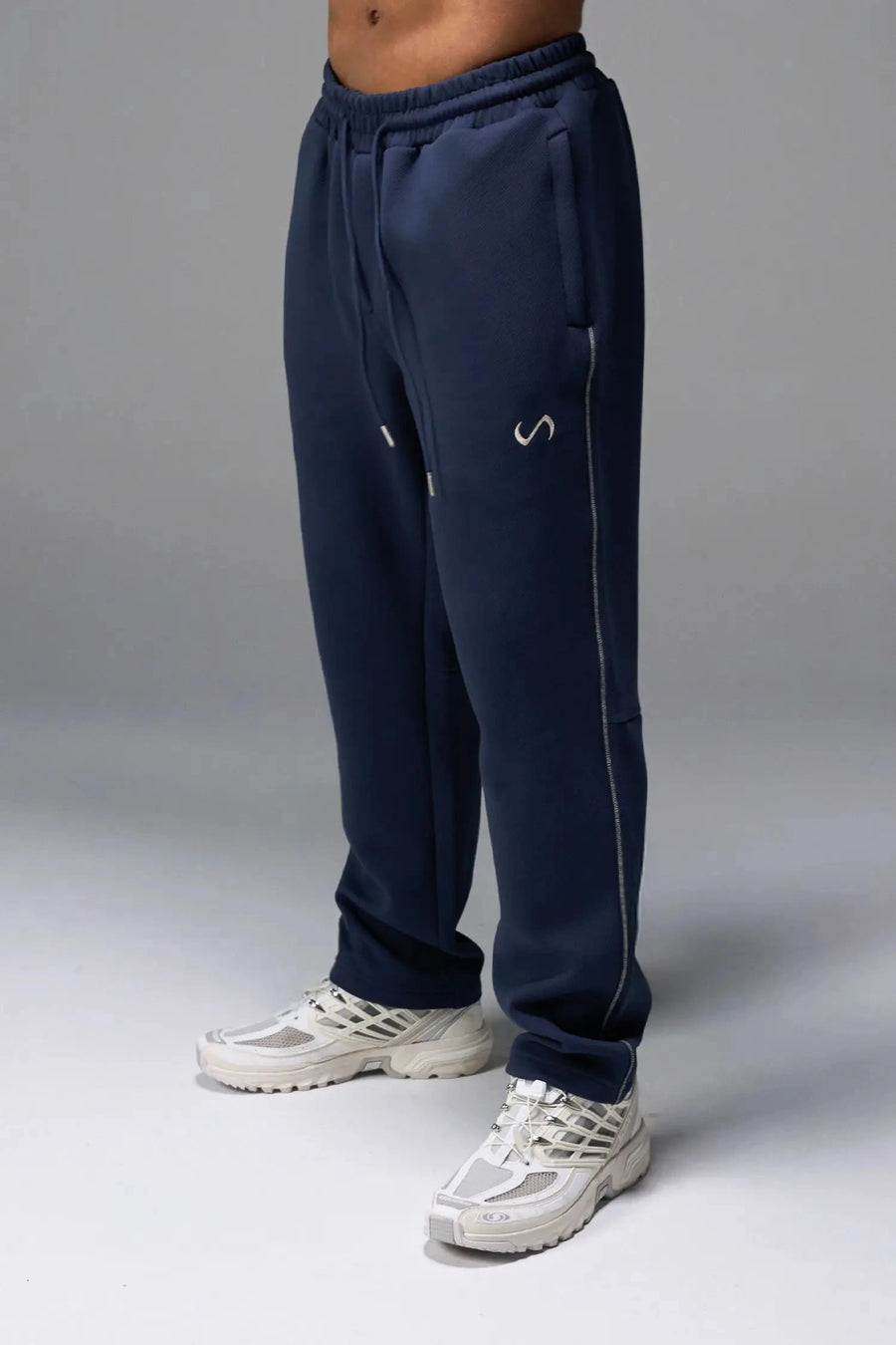 Front View of Blue TLF GTS Twill Tech Joggers, featuring contrast stitching, zippered pockets, and next level style and function