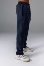 Side View of Blue TLF GTS Twill Tech Joggers, featuring contrast stitching, zippered pockets, and next level style and function