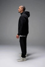 Front View of Black TLF GTS Twill Tech Quarter-Zip Hoodie, featuring contrast stitching, kangaroo pockets and unmatched style