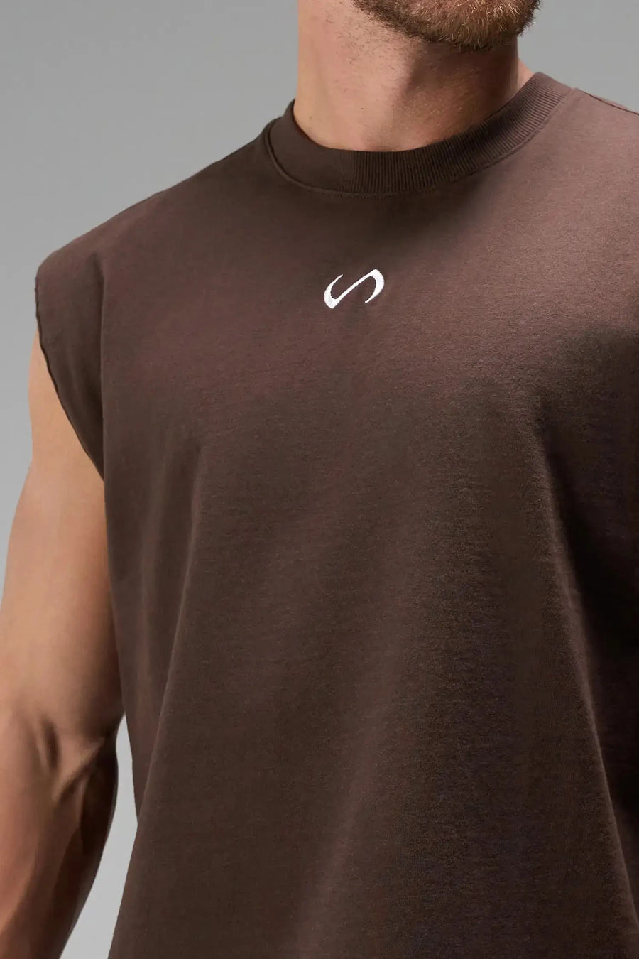 Front View of Brown the TLF Icon Muscle Tank featuring our physique enhancing design, straight hem and relaxed fit. 