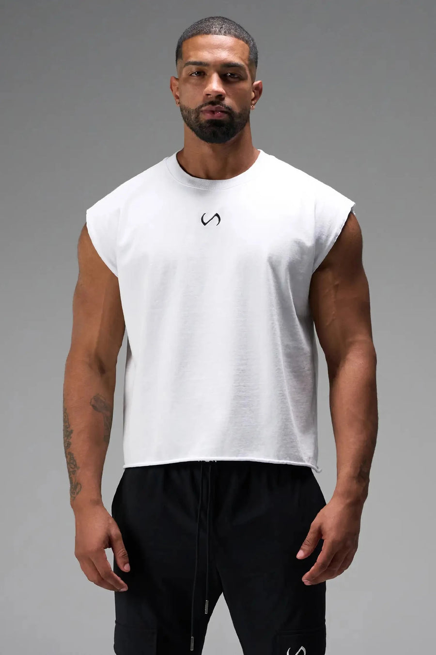 Front View of White the TLF Icon Muscle Tank featuring our physique enhancing design, straight hem and relaxed fit. 