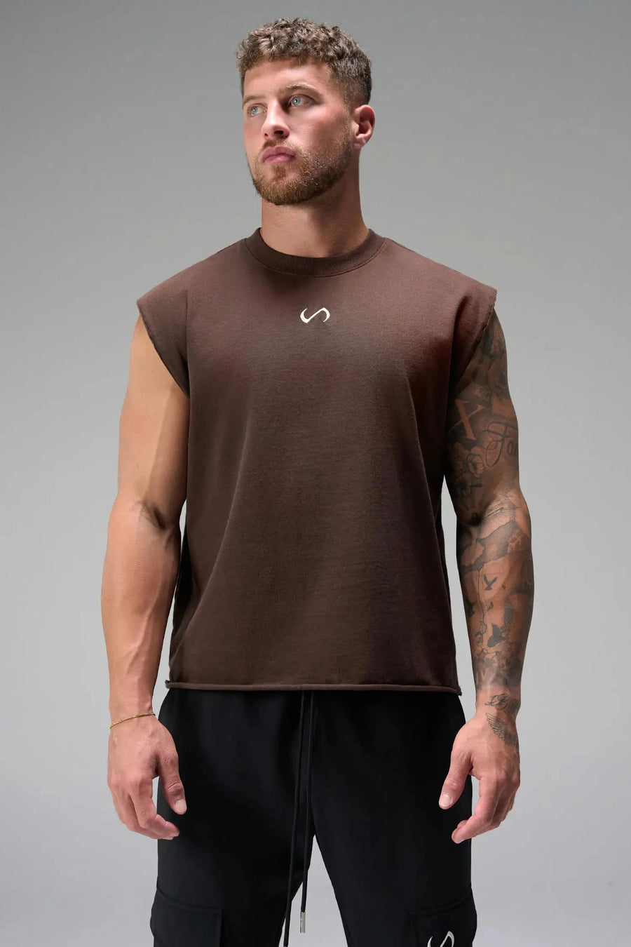 Front View of Brown the TLF Icon Muscle Tank featuring our physique enhancing design, straight hem and relaxed fit. 