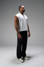 Side View of White the TLF Icon Muscle Tank featuring our physique enhancing design, straight hem and relaxed fit. 