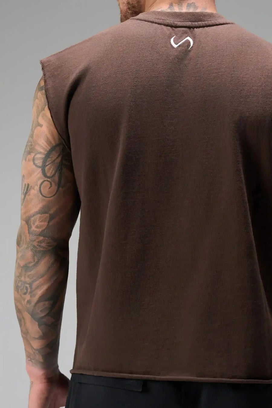 Back View of Brown the TLF Icon Muscle Tank featuring our physique enhancing design, straight hem and relaxed fit. 