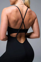 Back View of Black TLF NeoCloud™ Flare Jumpsuit featuring a built-in low support sports bra with removable pads and adjustable straps