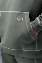 Detail Front View of Green TLF Scuba Tech Contrast Stitch Hoodie, featuring 3 panel hood, Kangaroo pockets and contrast stitching for streetwear aesthetic 