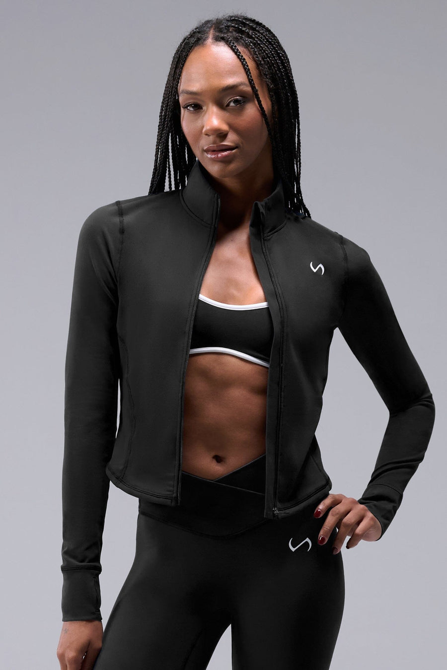 Front View of Black TLF Tempo Cropped Zip Up Jacket featuring thumbholes and cropped length for gym and lifestyle wear 