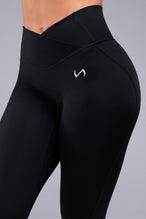 Side View of Black TLF Tempo Flare Leggings, featuring a waist snatching crossover waistband and glute shaping side seam 