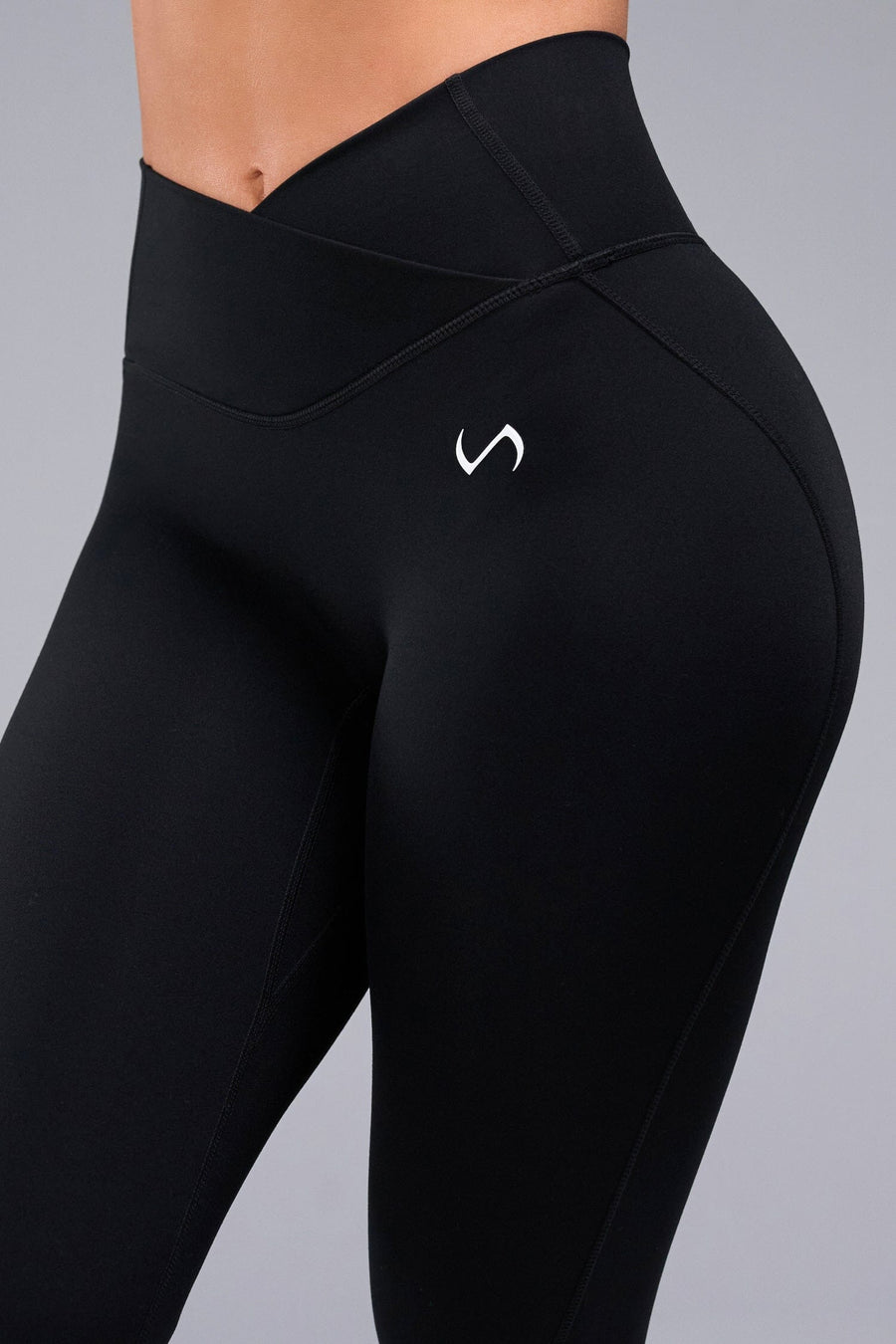 Side View of Black TLF Tempo Flare Leggings, featuring a waist snatching crossover waistband and glute shaping side seam 